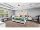 Open bedroom featuring modern furniture, an elegant tray ceiling, and large windows at 2077 Alcovy Trace Way, Lawrenceville, GA 30045