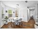 Bright dining area with modern lighting, wood floors, and easy kitchen access at 2077 Alcovy Trace Way, Lawrenceville, GA 30045