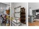 A well-organized entryway features a coat rack, shelving unit, and a glimpse into a cluttered garage area at 2077 Alcovy Trace Way, Lawrenceville, GA 30045