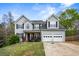 Charming two-story home with attached two-car garage, dark shutters, and a landscaped front yard at 2077 Alcovy Trace Way, Lawrenceville, GA 30045