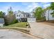 Traditional two-story home with a two-car garage, nicely landscaped front yard, and long driveway at 2077 Alcovy Trace Way, Lawrenceville, GA 30045