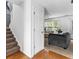 Bright foyer with hardwood floors, staircase, and an open view to the living room with comfortable seating at 2077 Alcovy Trace Way, Lawrenceville, GA 30045