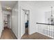 Upstairs hallway with a view into bedrooms and a railing overlooking the downstairs area at 2077 Alcovy Trace Way, Lawrenceville, GA 30045