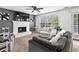 Comfortable living room featuring a fireplace, TV, plush seating, and bright windows at 2077 Alcovy Trace Way, Lawrenceville, GA 30045