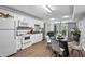 Bright kitchen and dining area with seating, adjacent to a living space at 2077 Alcovy Trace Way, Lawrenceville, GA 30045