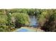 Scenic view of tennis and basketball courts with lake as the backdrop, surrounded by lush foliage at 4009 Glenlake Nw Trce, Kennesaw, GA 30144