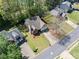 An aerial view showcases the home with mature trees, surrounding neighborhood, and well-manicured lawn at 4009 Glenlake Nw Trce, Kennesaw, GA 30144