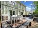Outdoor deck with dining area, grill, and white chairs, ideal for gatherings and enjoying the backyard at 4009 Glenlake Nw Trce, Kennesaw, GA 30144