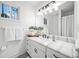 Bathroom with a marble countertop, black fixtures, and a window letting in natural light at 4009 Glenlake Nw Trce, Kennesaw, GA 30144