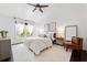 Bright bedroom with a vaulted ceiling, ceiling fan, a window letting in natural light, and a comfortable chair at 4009 Glenlake Nw Trce, Kennesaw, GA 30144