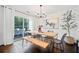 Stylish dining room with hardwood floors, modern lighting, and a sliding glass door to the outdoor area at 4009 Glenlake Nw Trce, Kennesaw, GA 30144