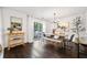 Elegant dining room featuring hardwood floors, a modern chandelier, and a sliding glass door to the backyard at 4009 Glenlake Nw Trce, Kennesaw, GA 30144