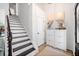 Bright foyer with hardwood floors, a staircase, and a storage unit creates an inviting entrance at 4009 Glenlake Nw Trce, Kennesaw, GA 30144