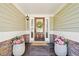 Inviting front porch with decorative wreath, address numbers and planters filled with bright pink flowers at 4009 Glenlake Nw Trce, Kennesaw, GA 30144