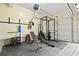Garage gym with weights, bench, squat rack and rubber flooring creating an at home fitness space at 4009 Glenlake Nw Trce, Kennesaw, GA 30144