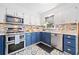 Charming kitchen with blue and white cabinets, granite countertops, and stainless steel appliances at 4009 Glenlake Nw Trce, Kennesaw, GA 30144