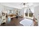 Airy living room featuring hardwood floors, large windows with curtains, and a comfortable seating area at 4009 Glenlake Nw Trce, Kennesaw, GA 30144