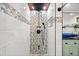 Bathroom shower with a mosaic tile wall, rain shower head, and handheld shower fixture at 4009 Glenlake Nw Trce, Kennesaw, GA 30144