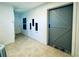 Bright entryway with unique architectural wall cutouts, featuring tile and wood flooring, and leading to a sliding barn door at 1382 Branch Dr, Tucker, GA 30084