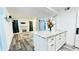 Open concept kitchen featuring a granite island, white cabinets and drawers, with a view into the living room at 1382 Branch Dr, Tucker, GA 30084