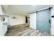 Open concept living room featuring wood floors, modern barn door and fireplace at 1382 Branch Dr, Tucker, GA 30084