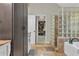 Elegant bathroom featuring a glass block shower, marble tile, and a soaking tub at 3405 River Ridge, Stockbridge, GA 30281