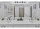 Beautiful bathroom featuring a dual vanity with black faucets, and a large mirror at 3405 River Ridge, Stockbridge, GA 30281