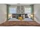 Bedroom featuring bright natural light, modern decor, and a cozy queen size bed with colorful pillows at 3405 River Ridge, Stockbridge, GA 30281