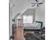 This bedroom features a sloped ceiling, ceiling fan, and natural light, creating a comfortable retreat at 3405 River Ridge, Stockbridge, GA 30281