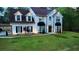 Two-story white brick home with a large front lawn and lovely landscaping at 3405 River Ridge, Stockbridge, GA 30281