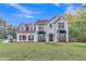 Charming two-story white brick home with manicured lawn and lovely landscaping at 3405 River Ridge, Stockbridge, GA 30281