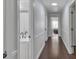A well-lit hallway with hardwood floors leading to a bedroom and a bathroom with modern fixtures at 3405 River Ridge, Stockbridge, GA 30281