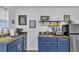 Cozy kitchen features blue cabinets, stainless steel appliances and wooden countertops at 3405 River Ridge, Stockbridge, GA 30281
