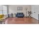 Inviting living room with wood floors, natural light, and a cozy blue loveseat at 3405 River Ridge, Stockbridge, GA 30281