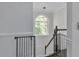 Stairwell with railing and an arched window at 3405 River Ridge, Stockbridge, GA 30281