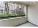 Relaxing balcony view featuring a black rail and views of green trees and a vintage lamp post at 1150 Collier Nw Rd # F11, Atlanta, GA 30318