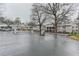 Gated community entrance with multiple apartment buildings and mature trees at 1150 Collier Nw Rd # F11, Atlanta, GA 30318