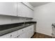 Modern kitchen with black granite countertops, stainless steel appliances and white cabinets at 1150 Collier Nw Rd # F11, Atlanta, GA 30318