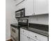 Kitchen featuring stainless steel appliances, granite countertops, white cabinets, and updated finishes at 1150 Collier Nw Rd # F11, Atlanta, GA 30318