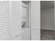 Convenient laundry area with stacked washer and dryer units and white shutter-style door at 1150 Collier Nw Rd # F11, Atlanta, GA 30318