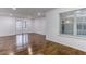Bright living room featuring gleaming hardwood floors, recessed lighting, and a double door to the outside at 1150 Collier Nw Rd # F11, Atlanta, GA 30318