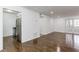 Open-concept floor plan, connecting living area with kitchen, hardwood floors, and double door to the outside at 1150 Collier Nw Rd # F11, Atlanta, GA 30318