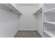 Spacious walk-in closet with shelving and carpet flooring at 1150 Collier Nw Rd # F11, Atlanta, GA 30318