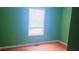 Bedroom featuring a large window, laminate floors and blue walls at 4443 Whitt Mill Nw Rd, Acworth, GA 30101