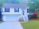 Charming split-level home featuring a two-car garage, classic white siding, and well-maintained landscaping at 4443 Whitt Mill Nw Rd, Acworth, GA 30101
