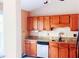 Well-lit kitchen with classic wood cabinets, granite countertops, and modern appliances at 4443 Whitt Mill Nw Rd, Acworth, GA 30101