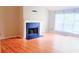 Spacious living room featuring a fireplace, large windows and laminate floors at 4443 Whitt Mill Nw Rd, Acworth, GA 30101