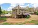 Spacious backyard features a large deck, patio, lush landscaping, and a beautiful exterior of the house at 111 Glen Trl, Woodstock, GA 30188