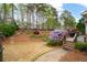 Lush backyard featuring landscaped garden, wooden deck and stone paver steps, perfect for outdoor relaxation at 111 Glen Trl, Woodstock, GA 30188