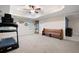 Spacious carpeted basement featuring a vintage church pew, treadmill, mirror, and large windows at 111 Glen Trl, Woodstock, GA 30188